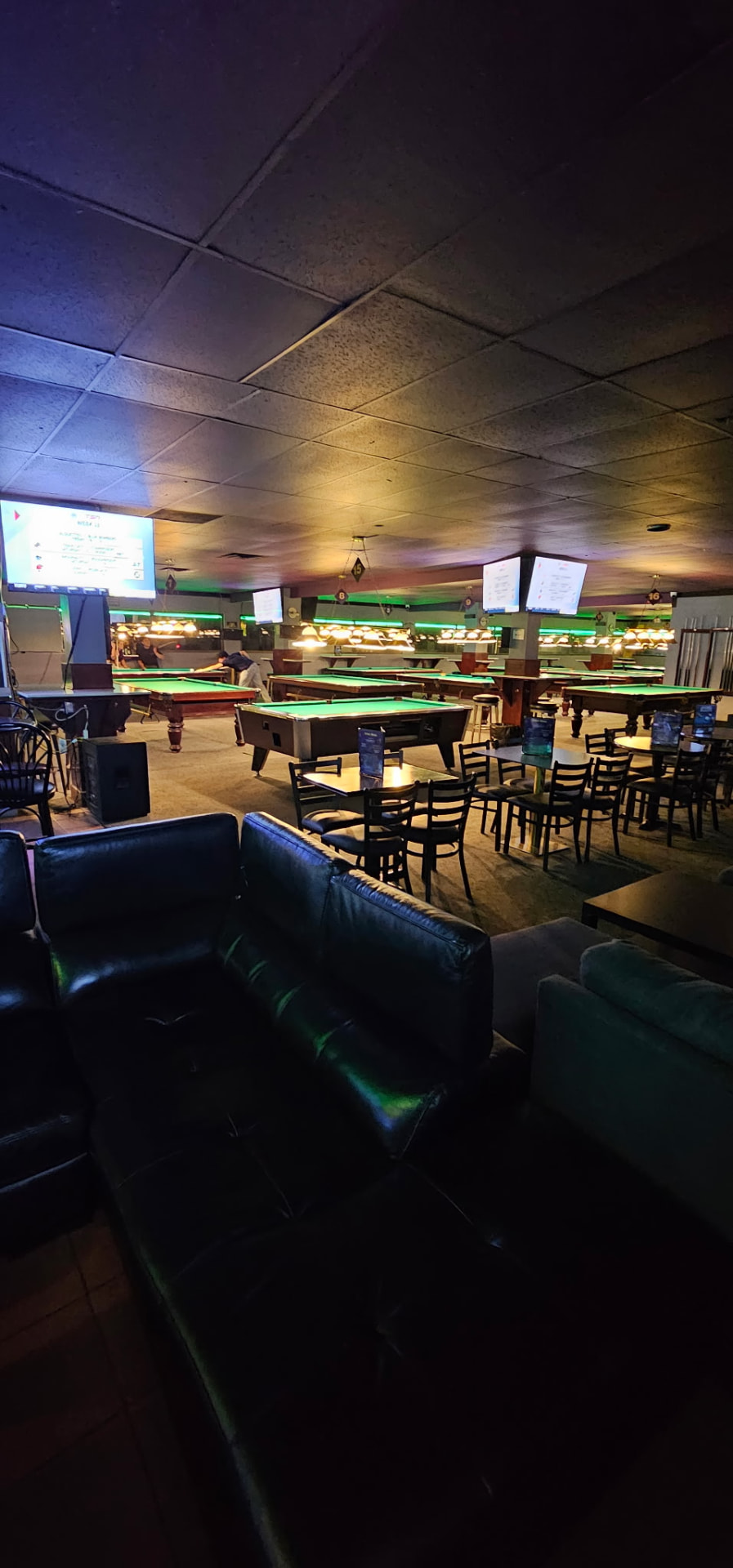 Leather lounge seating beside the pool tables at Boulevard Billiards